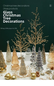 Detailed view of elegant glass Christmas tree ornaments on white soft velvet background