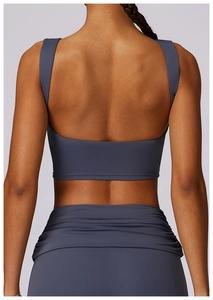 Close-up of the deep grey U-shaped open back sports vest and ruched waist detail