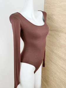 Detail of dark brown ribbed knit bodysuit showing stretchy texture and snug fit