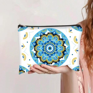 Detailed view of evil eye mandala travel pouch with blue patterns and black zipper
