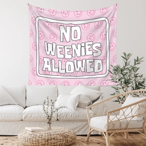 Bohemian pink tapestry featuring smile patterns and No Weenies Allowed quote in a room