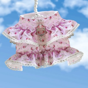 Detailed view of pink floral pet harness with lace trim and metal D-ring attachment