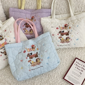 Quilted cotton tote bags with cute puppy embroidery and pastel colors on plush rug