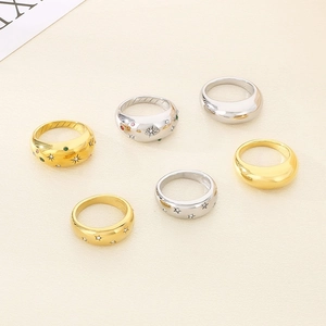 Collection of gold and silver stainless steel rings with star patterns and zircon stones