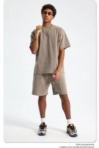 Detail of washed brown cotton streetwear set showing distressed texture and oversized fit