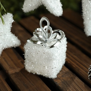 White Christmas foam gift box ornament with silver ribbon handle on wooden background