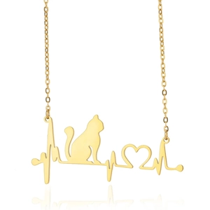 Macro shot of gold cat pendant with heart and heartbeat line on a fine link chain