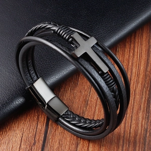 Detailed view of multilayer black leather bracelet with black metal cross and magnetic clasp