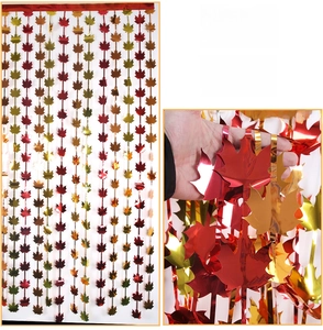 Detail of maple leaf foil curtain in red and gold for Thanksgiving party decoration