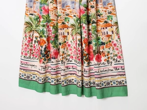 Detailed close-up of midi skirt hem showing Mediterranean print and cotton linen texture