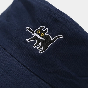 Detailed view of deep blue bucket hat with funny black cat embroidery on cotton fabric