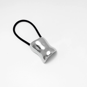 Détail d'élastique à cheveux noir avec pièce géométrique irrégulière en argent poli
