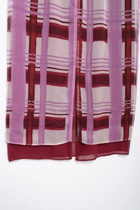Detail showing the double-layer fabric with burgundy plaid chiffon and solid inner lining