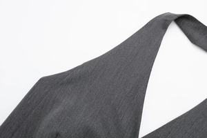 Détail du tissu sergé gris foncé montrant le col licou et les coutures précises