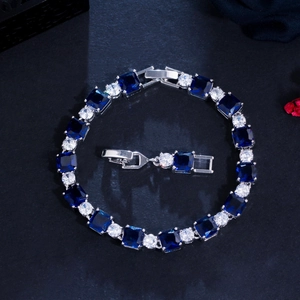 Detail of blue square zirconia and round white stones on a silver plated brass bracelet