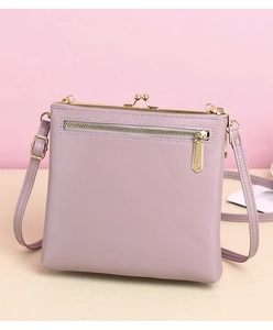 Detail of purple faux leather crossbody bag featuring vintage kiss-lock and back zipper pocket