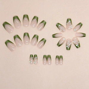 French aurora green glitter press-on nails with butterfly and pearl accents in short ballet style