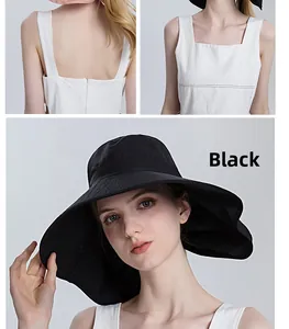 Detail of a wide brim black sun hat with ponytail hole for women in summer outdoor settings