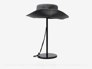 Detail of dark grey sun hat with adjustable drawstring and metal ventilation holes