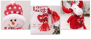 Detail of Christmas snowman and reindeer dolls with red knitted textures and heart patterns