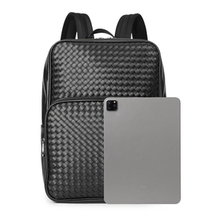 Detail of premium black woven leather texture on a high-capacity business backpack