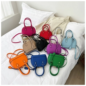 Collection of shell bags with stone pattern and double handles in ten vibrant colors