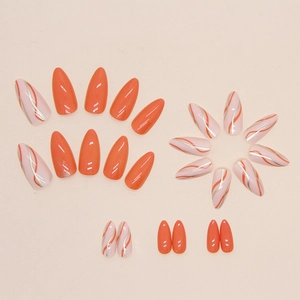 Orange almond press-on nails featuring solid color and silver-edged wave patterns