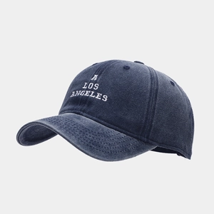 Detail of blue washed cotton baseball cap with white A Los Angeles embroidery and stitching