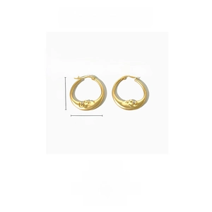 Detailed view of 14K gold plated moon earrings with face relief and rhinestone