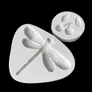 Detailed white silicone mold set featuring dragonfly and cherry shapes for cake decorating