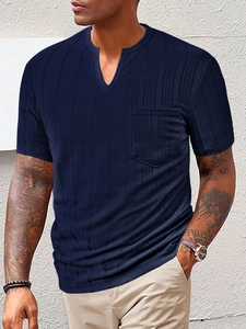 Macro detail of dark blue short sleeve shirt featuring V-neckline and textured fabric weave
