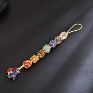 Detail of 7 chakra natural raw stones hanging decor with woven net and crystal tassels