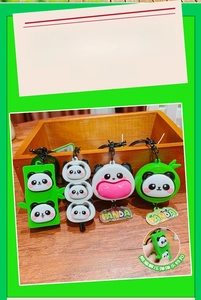 Green and white panda fidget toy keychain with flexible squeeze feature and panda tag