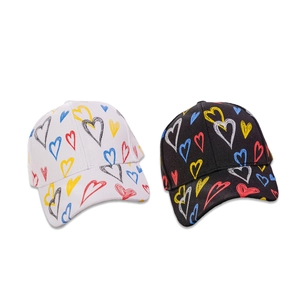 Set of black and white baseball caps with colorful hand-drawn heart patterns