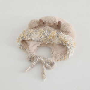 Detail of soft beige plush kids hat with deer antlers and knit trim for winter warmth