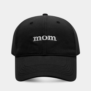 Close-up of white 3D embroidered mom letters on a black cotton baseball cap detail