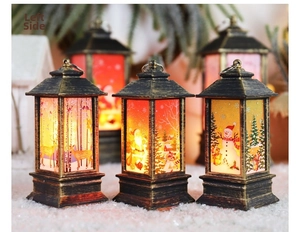 Detail of vintage bronze Christmas lanterns with warm LED light on faux snow background