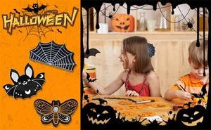 Close-up of Halloween enamel pins with spider web, cat bat, and skull moth designs
