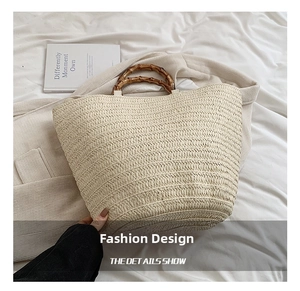 Detail view of woven straw tote bag with natural bamboo handles and textured surface