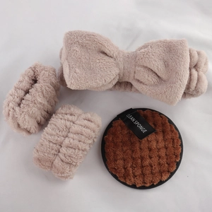 Detail of plush beige headband with wristbands and a brown clean sponge set