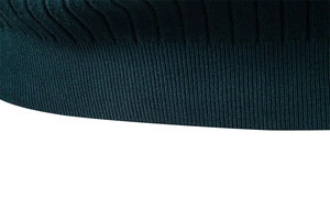 Detail shot of the rib-knit cuff texture and dark green yarn on a men's turtleneck sweater