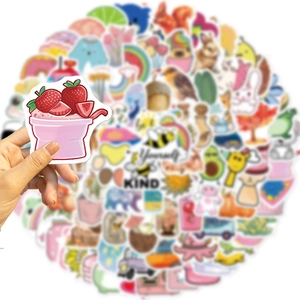 Close-up of hand holding colorful waterproof cartoon stickers with Be Yourself text