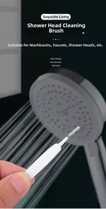 Close-up of white shower head cleaning brush effectively clearing fine nozzle holes