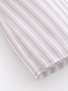 Close-up of gray and white striped fabric showing fine stitching details and smooth texture