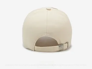 Detail view of the back of a beige baseball cap with metal buckle and star embroidery