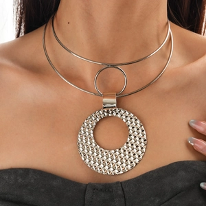 Detail of silver double-layer choker featuring a large textured round woven pendant