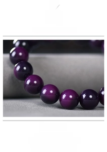 Macro view of smooth purple Bodhi seed prayer beads showing translucent jade texture