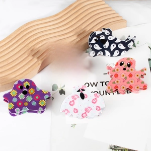 Ghost-shaped Halloween hair claws in various colorful floral and checkered acetate patterns