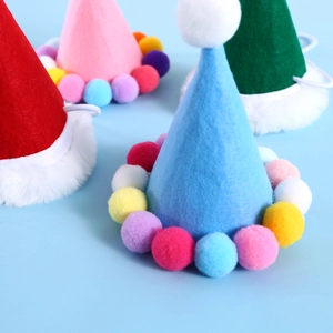 Close-up of colorful felt party hats for pets with soft pom-pom trim and elastic chin straps