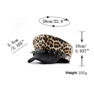 Detailed view of leopard print beret with silver spiked rivets and black leather strap